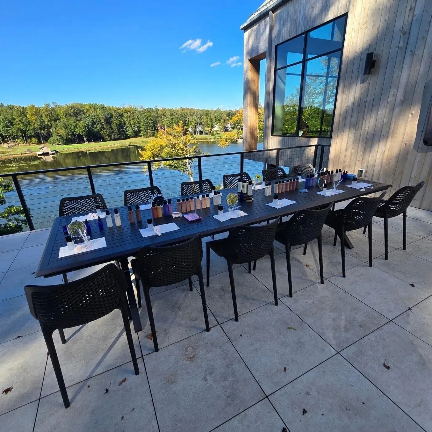 A product and tools table set up along the lakeside deck, ready for a retreat session