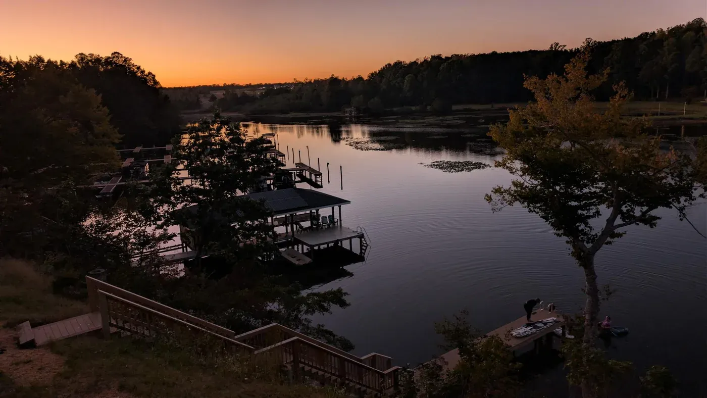 Sunset over the lake and boat docks at the retreat venue