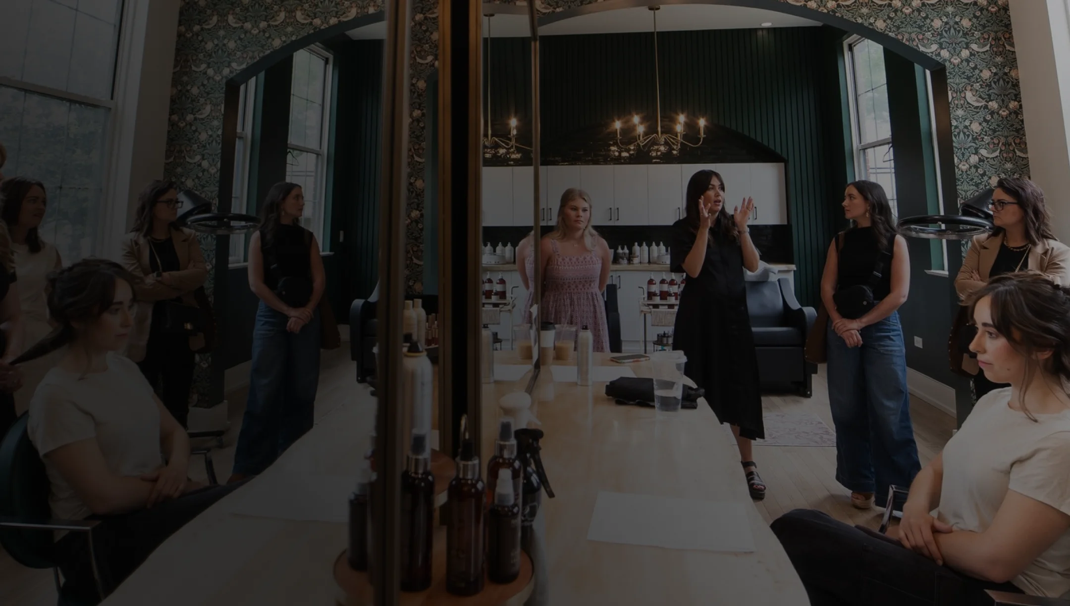 Beauty professionals gathered in a Root & Bloom partner salon during an education evening