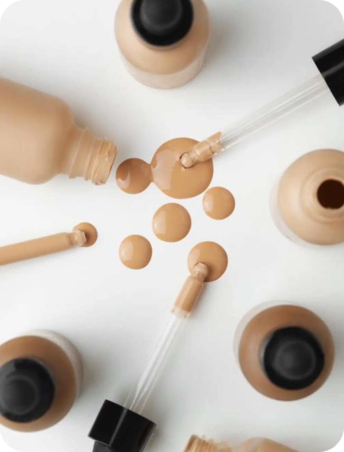Custom blended mineral cosmetics, brushes and compacts laid out on a pale surface